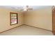 This carpeted bedroom is bright with a ceiling fan and features a large window at 68 Spring Lake Dr, Debary, FL 32713