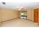 Spacious bedroom with neutral carpet and walk-out access to a screened patio, enhancing indoor/outdoor living at 68 Spring Lake Dr, Debary, FL 32713