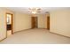 Neutral bedroom featuring a ceiling fan, carpeting, and three doors leading to other areas of the house at 68 Spring Lake Dr, Debary, FL 32713
