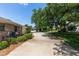 Long driveway leading to a single Gathering home with lush landscaping and an attached two car garage at 68 Spring Lake Dr, Debary, FL 32713