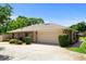A single Gathering home featuring a two-car garage, with a driveway, and mature landscaping at 68 Spring Lake Dr, Debary, FL 32713