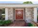 Close-up of front entrance with double doors, brick walkway, and manicured landscaping, showcasing welcoming curb appeal at 68 Spring Lake Dr, Debary, FL 32713