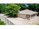Aerial view of a detached two-car garage with driveway, backyard with patio, and private fencing at 68 Spring Lake Dr, Debary, FL 32713