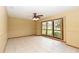 Bright living room with large windows, tile flooring, and neutral walls, creating an airy and welcoming space for entertaining at 68 Spring Lake Dr, Debary, FL 32713