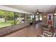 Covered brick patio with ceiling fan and view of the backyard and pergola at 68 Spring Lake Dr, Debary, FL 32713