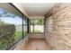 Covered brick patio showing the open green lawn and blue skies at 68 Spring Lake Dr, Debary, FL 32713