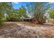 The property features a large backyard surrounded by lots of shade trees at 688 Cumberland Rd, Deland, FL 32724