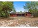 The backyard features a red wood panel exterior with a covered lanai at 688 Cumberland Rd, Deland, FL 32724