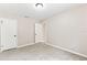 Cozy bedroom featuring neutral walls, carpeted flooring, and closet and bathroom doors at 688 Cumberland Rd, Deland, FL 32724