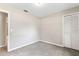 Cozy bedroom featuring neutral walls, carpet, a built-in closet, and a bathroom entrance at 688 Cumberland Rd, Deland, FL 32724