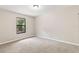 Inviting bedroom with natural lighting, neutral walls, and plush carpeting for a warm, relaxing feel at 688 Cumberland Rd, Deland, FL 32724