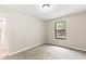 Bright bedroom with neutral walls, carpet flooring, and a window overlooking the backyard at 688 Cumberland Rd, Deland, FL 32724