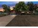 Charming single-story home featuring a brick facade, mature trees, and a well-maintained front yard at dusk at 688 Cumberland Rd, Deland, FL 32724