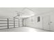 Spacious garage with white walls, a large garage door, window, and exterior door at 688 Cumberland Rd, Deland, FL 32724