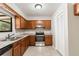 Cozy kitchen featuring wooden cabinets, stainless steel appliances, and granite countertops with a window over the sink at 688 Cumberland Rd, Deland, FL 32724