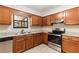 Kitchen with wood cabinets, stainless steel appliances and granite counter tops, offering a practical cooking space at 688 Cumberland Rd, Deland, FL 32724