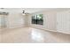 Bright living room with tile flooring, a ceiling fan, and a large window offering ample natural light at 688 Cumberland Rd, Deland, FL 32724