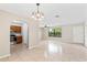 Bright living room adjacent to an open kitchen, featuring neutral walls, tile flooring and ceiling fan at 688 Cumberland Rd, Deland, FL 32724