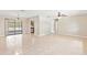Spacious living area with tile floors, leading to screened porch and kitchen, offering open concept living at 688 Cumberland Rd, Deland, FL 32724