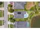 Aerial view of home with a pool, solar panels and a well-manicured lawn at 6917 Vintage Ln, Port Orange, FL 32128