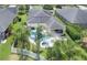Aerial view of a beautiful home with a pool and a screened-in patio with lush landscaping at 6917 Vintage Ln, Port Orange, FL 32128