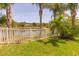 Private backyard featuring a white fence and beautiful lake views beyond at 6917 Vintage Ln, Port Orange, FL 32128
