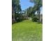 Lush backyard with well-maintained lawn, mature trees, and privacy landscaping at 6917 Vintage Ln, Port Orange, FL 32128