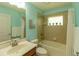 Bright bathroom with tile surround, a vanity sink, and a shower-tub combo at 6917 Vintage Ln, Port Orange, FL 32128