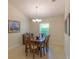Cozy dining room with wooden table set and natural light from the window at 6917 Vintage Ln, Port Orange, FL 32128