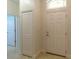 Welcoming foyer featuring a tile floor, closet and a front door with a transom window at 6917 Vintage Ln, Port Orange, FL 32128