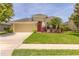 Charming one story home with a well-manicured lawn and colorful landscaping at 6917 Vintage Ln, Port Orange, FL 32128