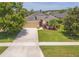 Beautiful single-story home boasting lush landscaping and an attached two-car garage at 6917 Vintage Ln, Port Orange, FL 32128