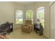 Well-lit home office with a comfortable recliner and bay windows at 6917 Vintage Ln, Port Orange, FL 32128