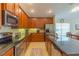 Spacious kitchen featuring granite countertops, tiled flooring, and stainless steel appliances at 6917 Vintage Ln, Port Orange, FL 32128