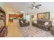 Open-concept living room with tile flooring, furniture, and seamless flow to the kitchen at 6917 Vintage Ln, Port Orange, FL 32128
