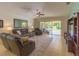 Comfortable living room featuring leather furniture and a view of the backyard at 6917 Vintage Ln, Port Orange, FL 32128