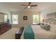 Relaxing main bedroom with a king-size bed, dresser, and dual windows at 6917 Vintage Ln, Port Orange, FL 32128