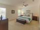 Relaxing main bedroom with a king-size bed, dresser, and dual windows at 6917 Vintage Ln, Port Orange, FL 32128