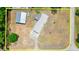 This aerial view showcases the house, outbuildings, and surrounding property at 793 Timothy St, Ormond Beach, FL 32174