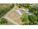 An aerial view of a property with a metal roofed house and barn surrounded by a yellow boundary line at 793 Timothy St, Ormond Beach, FL 32174