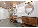 Bathroom with double vanity, oval mirrors, wooden ceiling and stone floor at 793 Timothy St, Ormond Beach, FL 32174