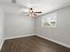 Serene bedroom with wood-look floors, a ceiling fan, and a sunlit window for a peaceful ambiance at 793 Timothy St, Ormond Beach, FL 32174