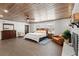 Spacious bedroom featuring a wooden ceiling, brick fireplace, and wood flooring at 793 Timothy St, Ormond Beach, FL 32174