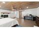 Large main bedroom has vaulted ceiling, hardwood floors, barn door and a brick fireplace at 793 Timothy St, Ormond Beach, FL 32174