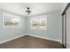 Bright bedroom with wood-look floors, large windows, and a ceiling fan for a cool and airy feel at 793 Timothy St, Ormond Beach, FL 32174