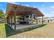 Carport for RV, featuring a metal roof and concrete foundation at 793 Timothy St, Ormond Beach, FL 32174