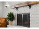 A freshly painted fireplace has a wood beam mantel and a metal screen in front at 793 Timothy St, Ormond Beach, FL 32174