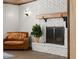 Living space features a brick fireplace, hardwood floors, and comfortable seating at 793 Timothy St, Ormond Beach, FL 32174
