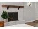 A freshly painted fireplace has a wood beam mantel and a metal screen in front at 793 Timothy St, Ormond Beach, FL 32174