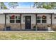 Well-maintained lawn and covered porch with flower baskets at 793 Timothy St, Ormond Beach, FL 32174